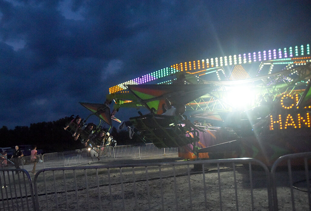 Children and teenagers cheer and sing as they enjoy the Cliff Hanger ride